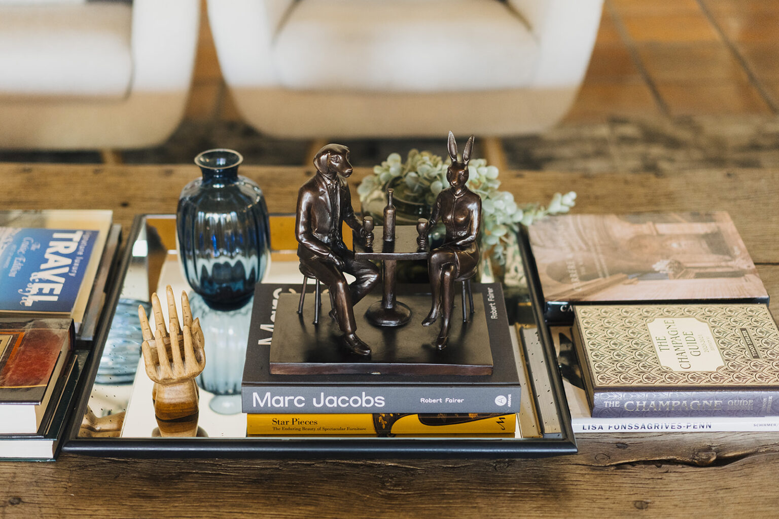 Styled coffee table with books and sculptures at Tower Lodge