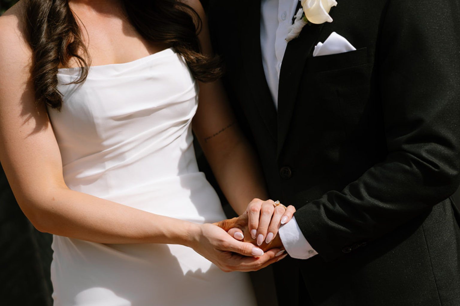 Close-up of the couple holding hands at Tower Lodge