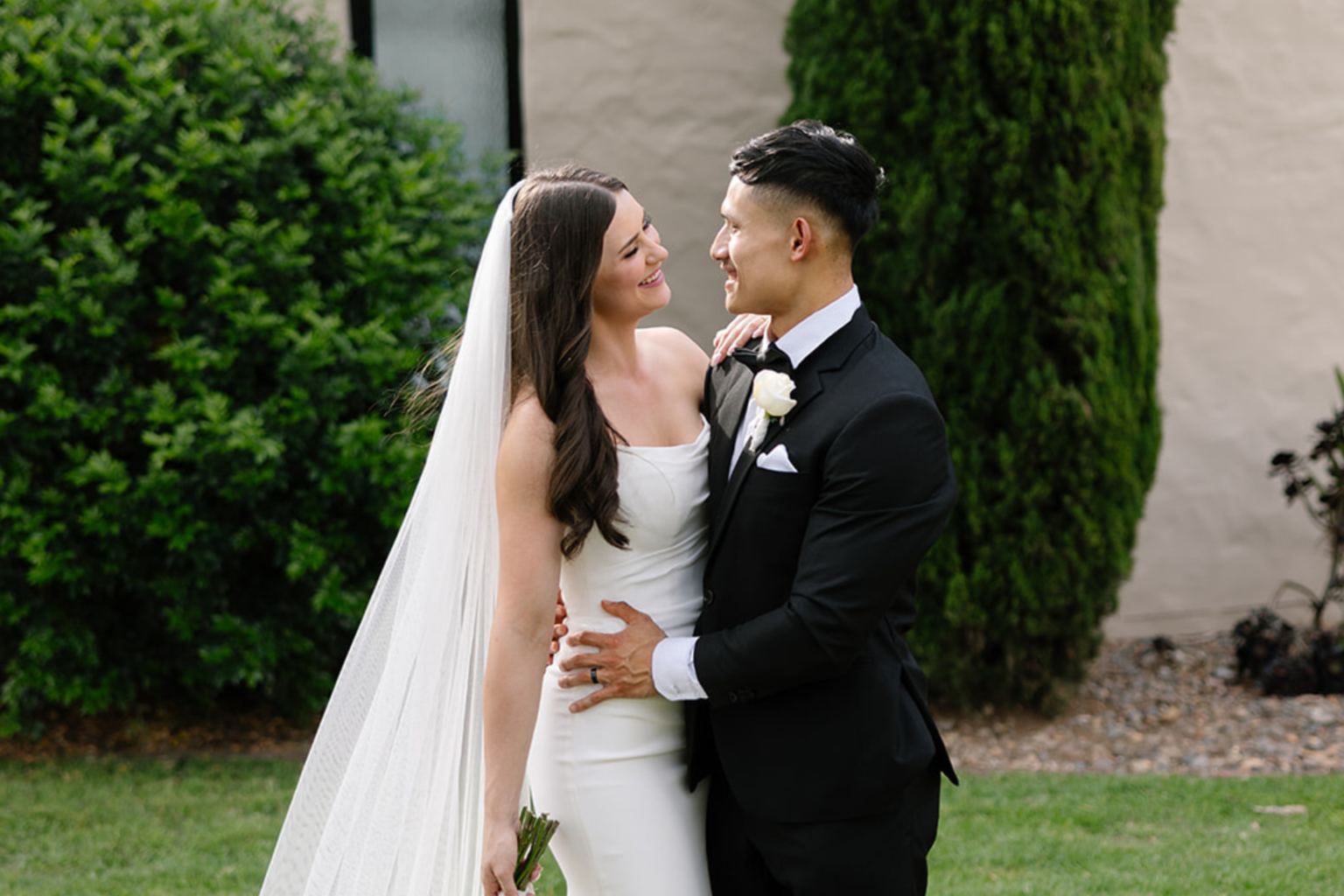 Bride and groom embracing in the gardens at Tower Lodge