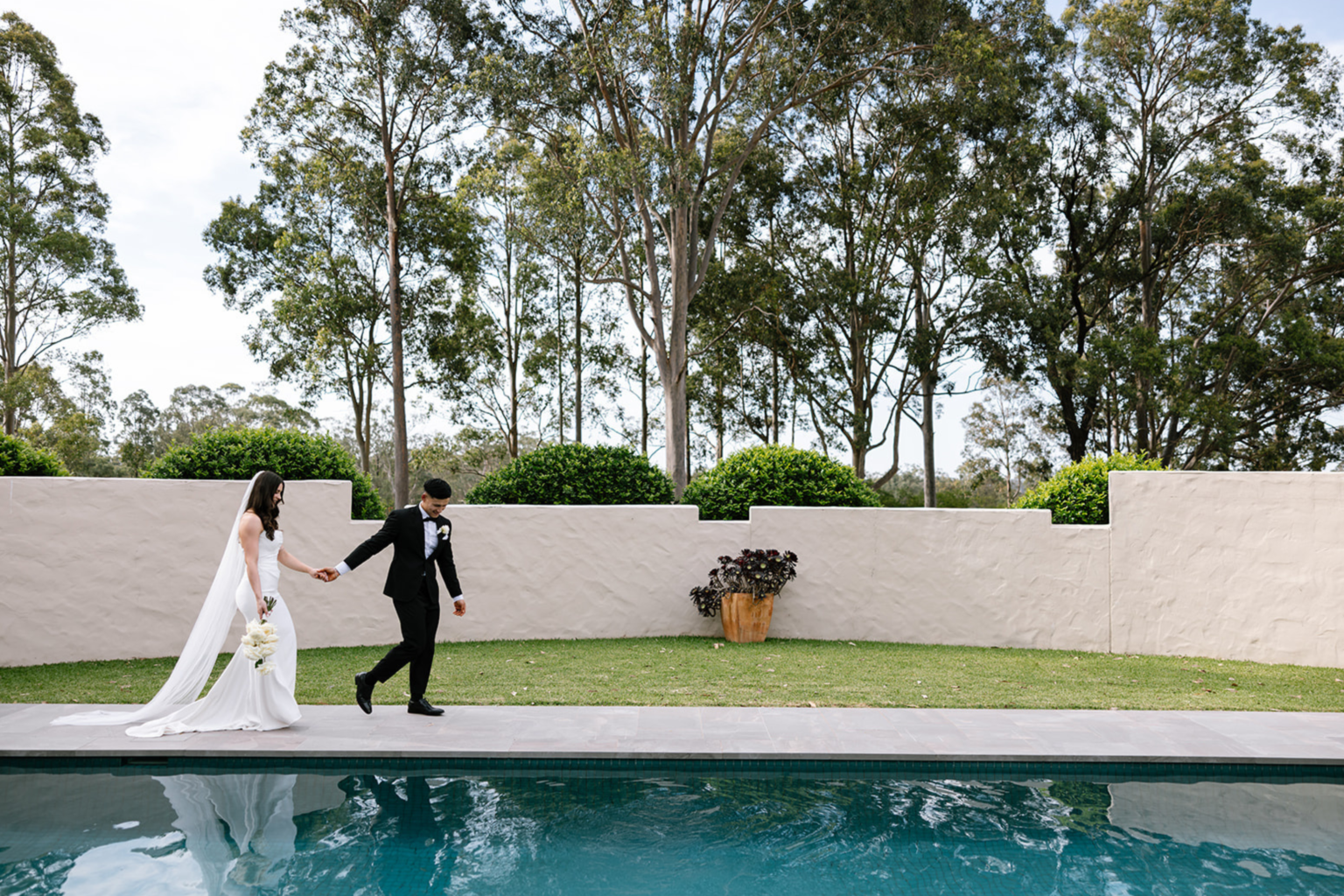 Couple walking beside the pool at Tower Lodge