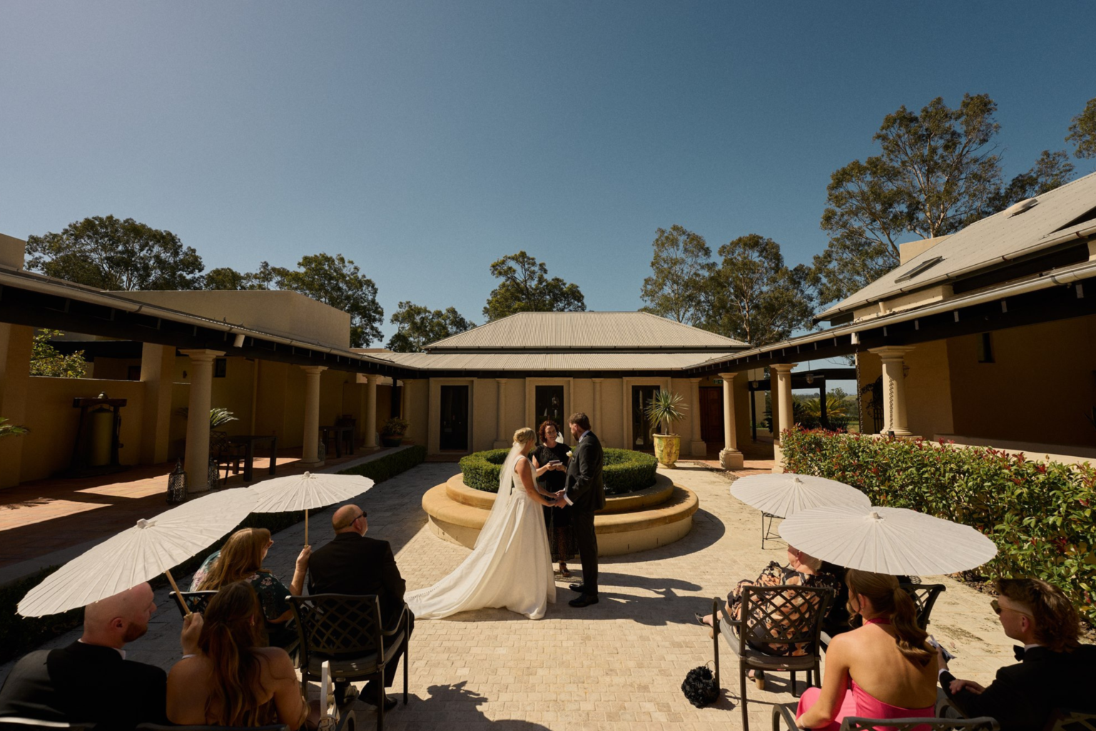 Intimate courtyard ceremony with guests at Tower Lodge