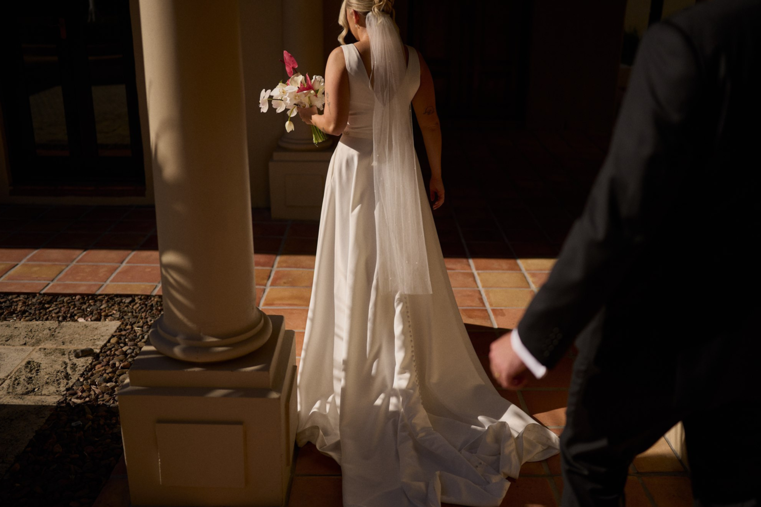 Bride and groom walking through Tower Lodge's interior