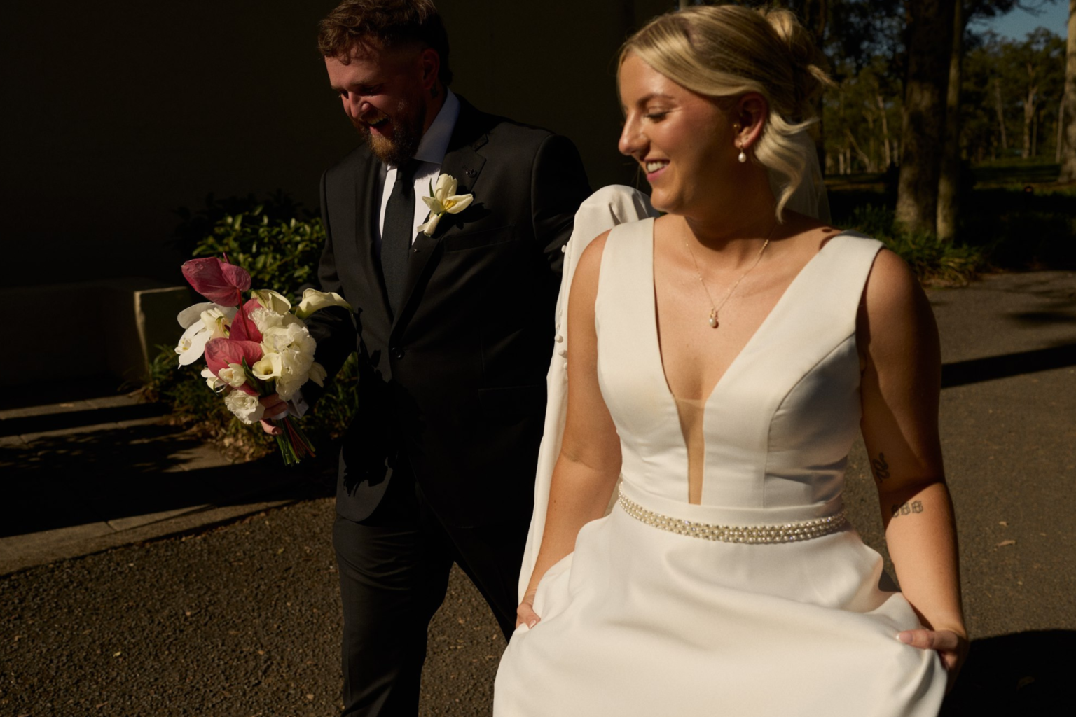 Bride and groom laughing in golden light at Tower Lodge