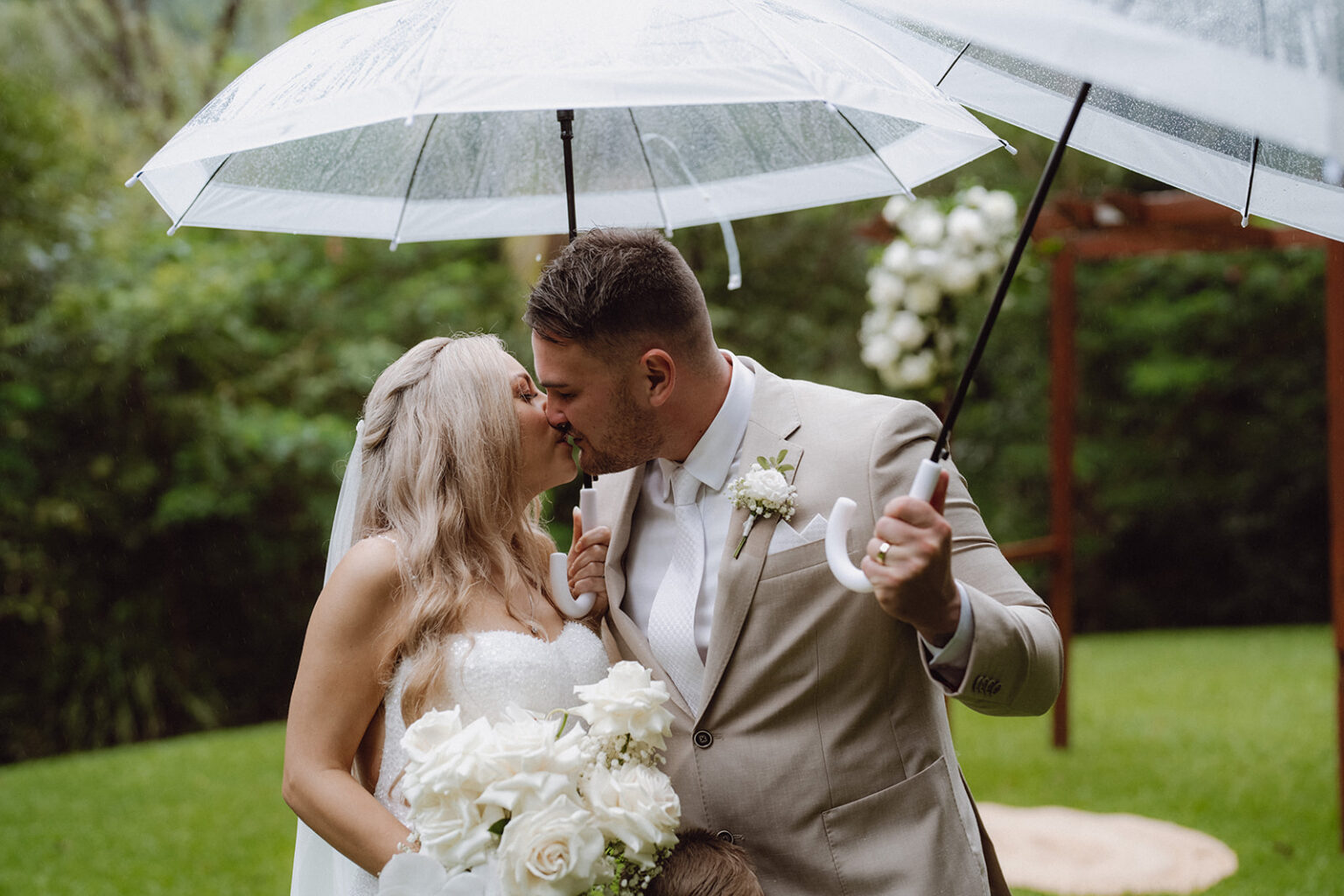 Couple kissing under a clear umbrella