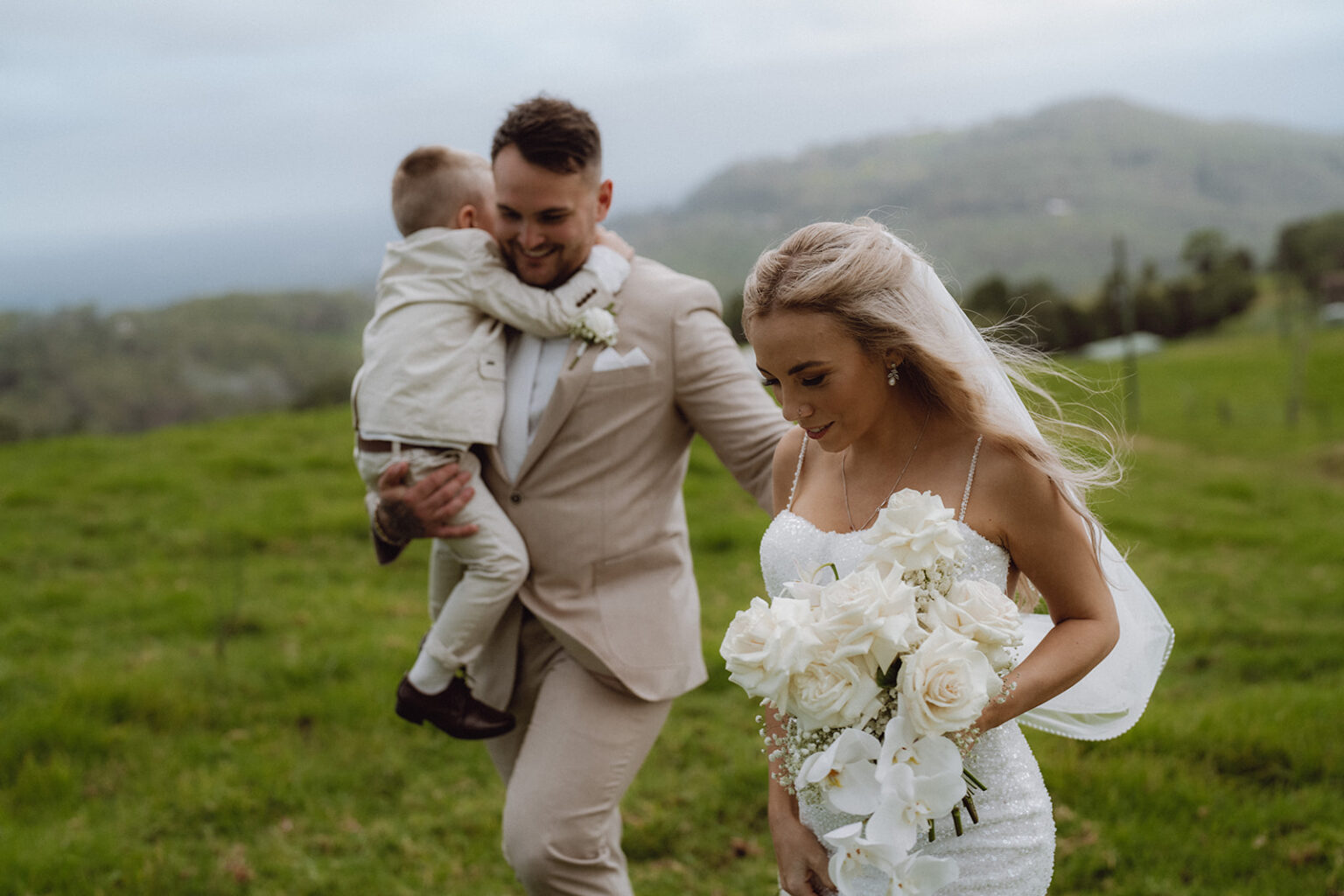 Couple walking across the paddock with their young son