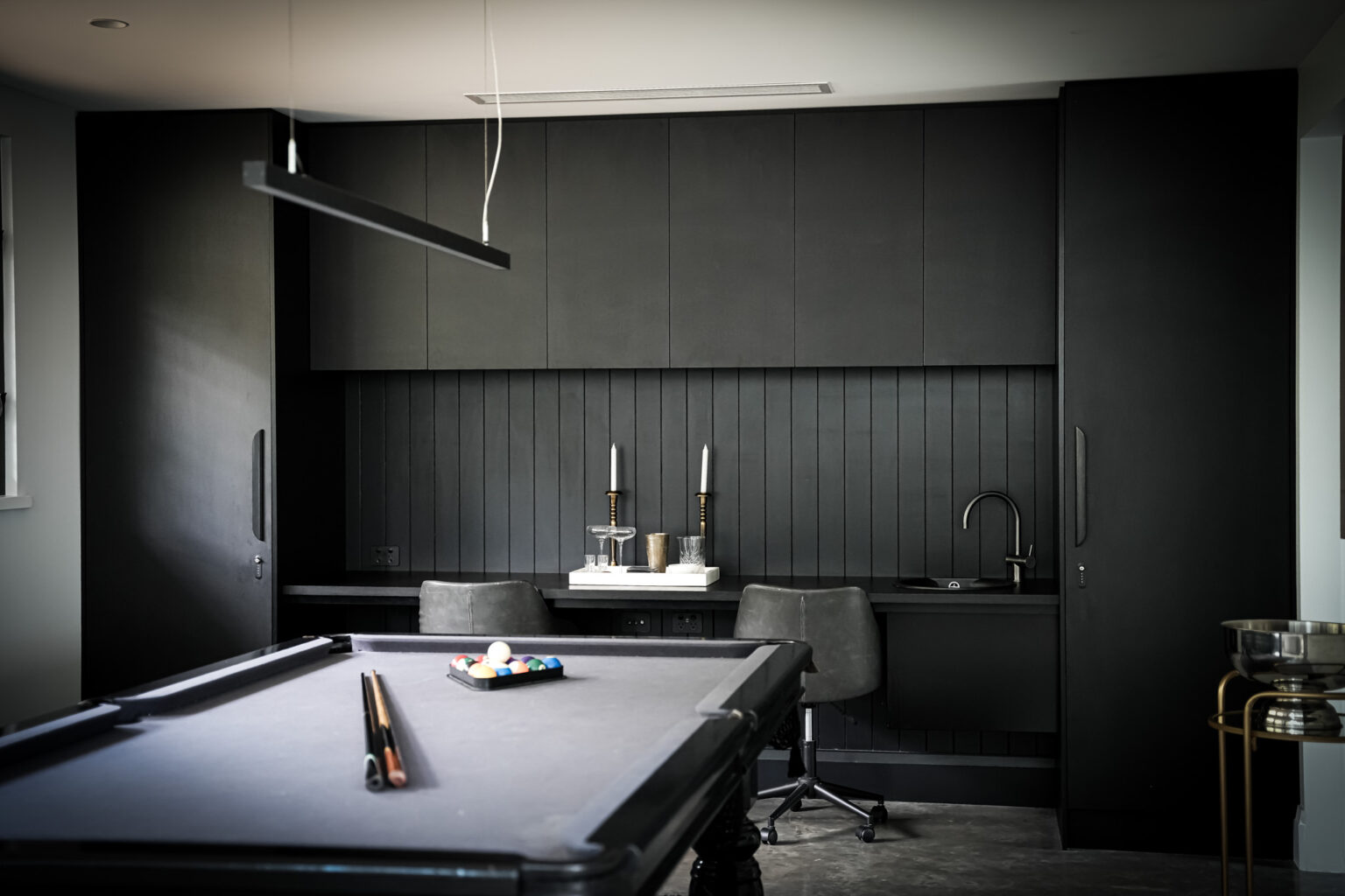 Billiards room with dark timber cabinetry at La Belle Vallée