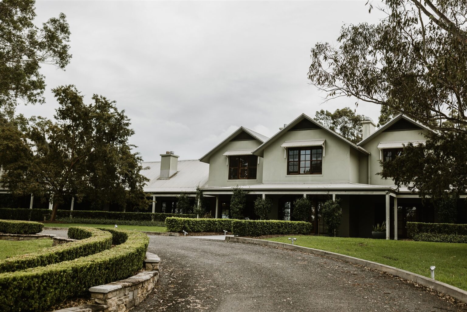 Driveway and manicured hedges leading to the homestead