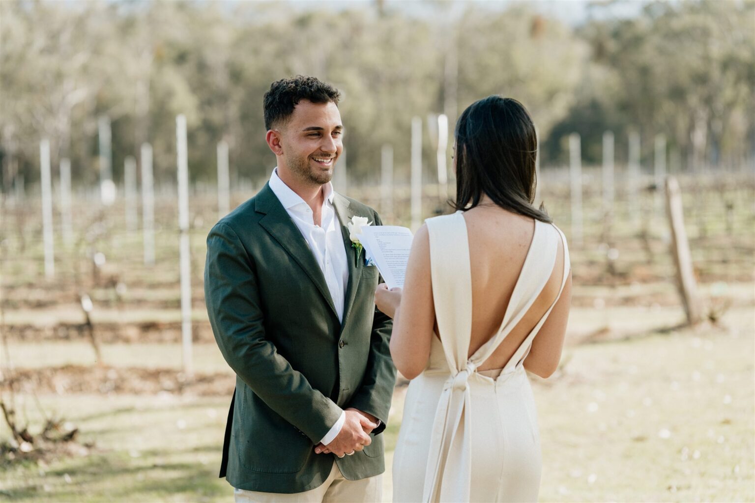 Couple exchanging vows among the vines at Spicers Vineyards Estate