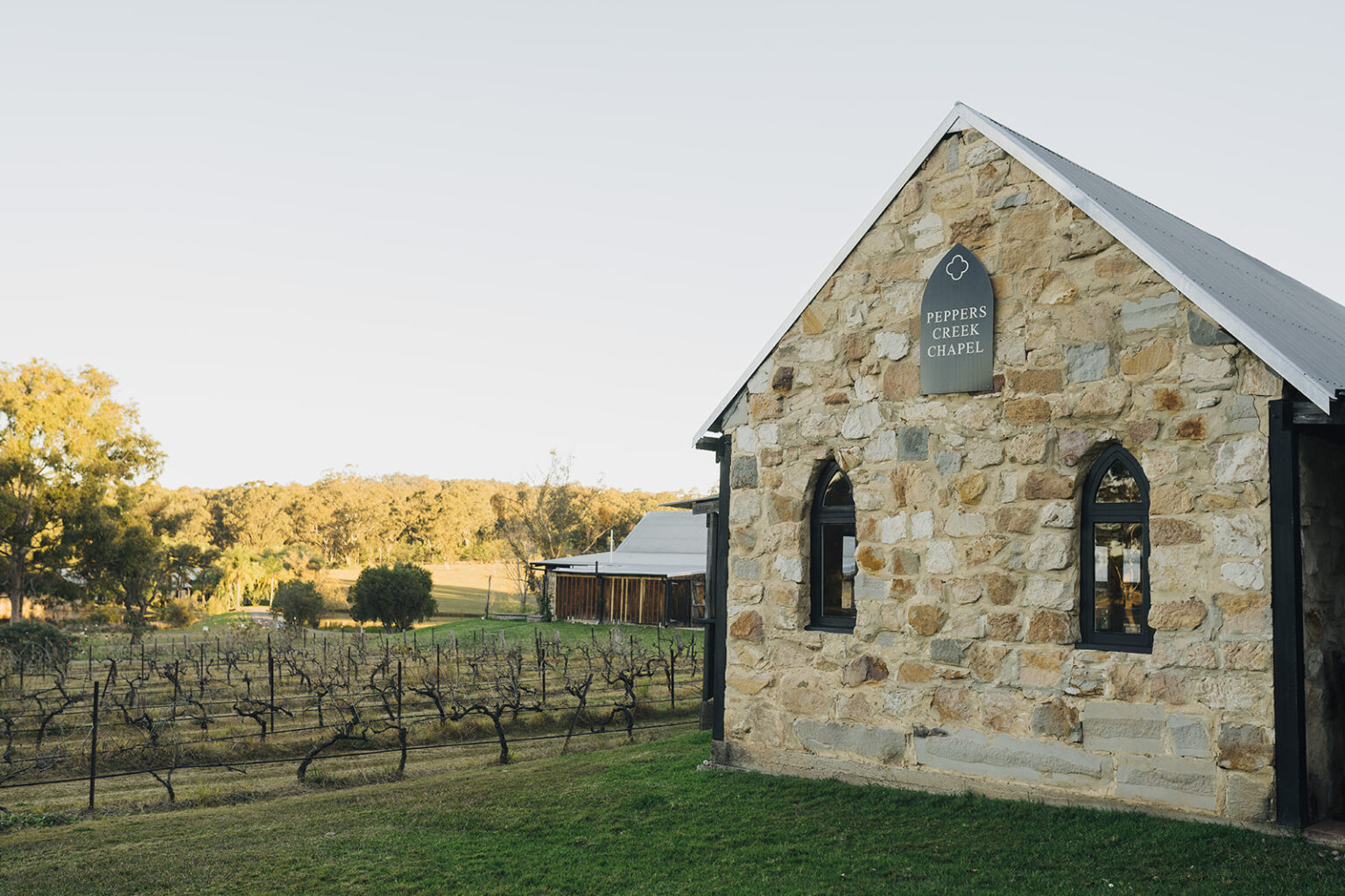Sandstone chapel beside the vineyard at golden hour