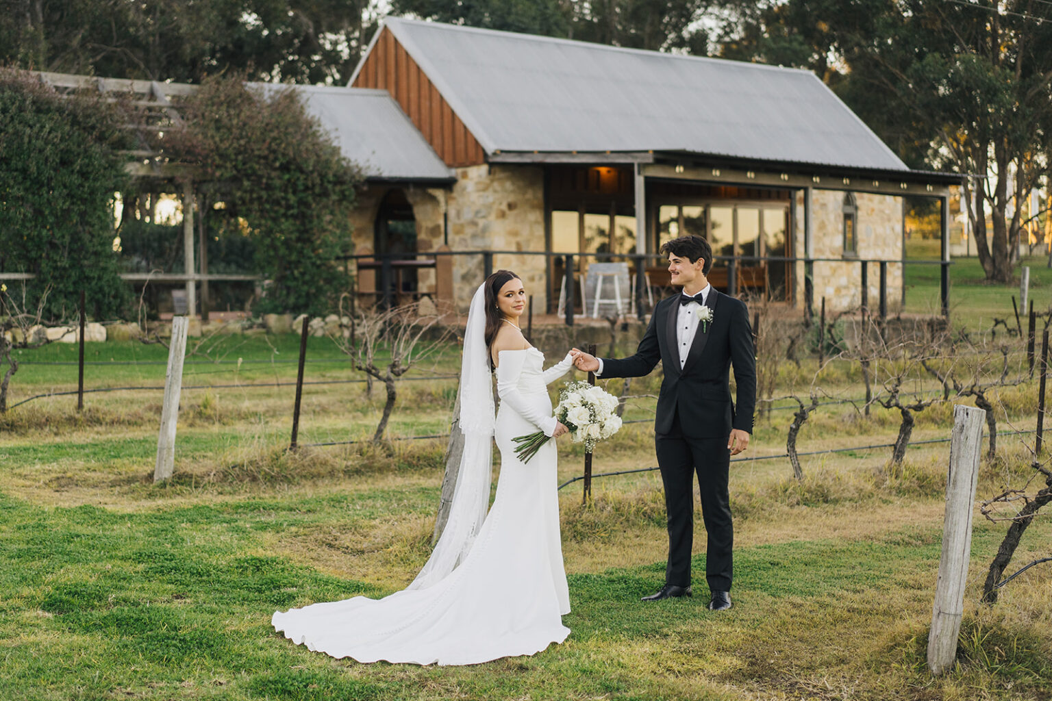 Bride and groom in the vineyard in front of the Barrel Room