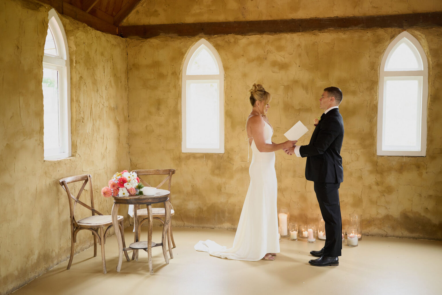 Couple reading their vows inside the sandstone chapel at Peppers Creek
