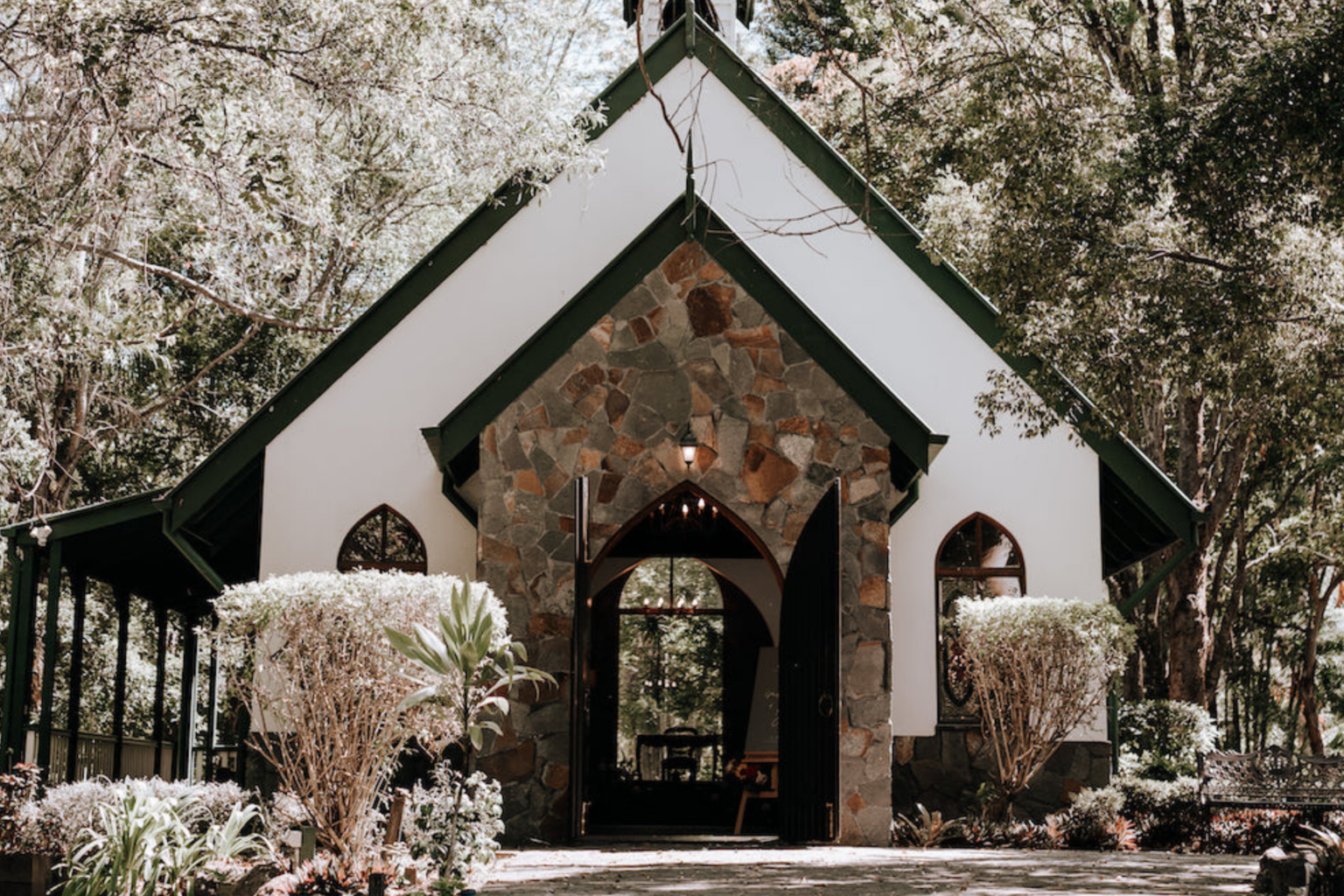 Stone chapel entrance framed by gardens at Coolibah Downs