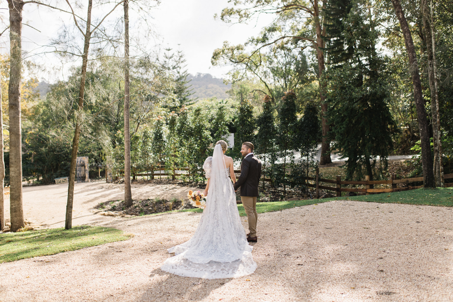 Couple on the gravel courtyard among the trees at Kwila Lodge
