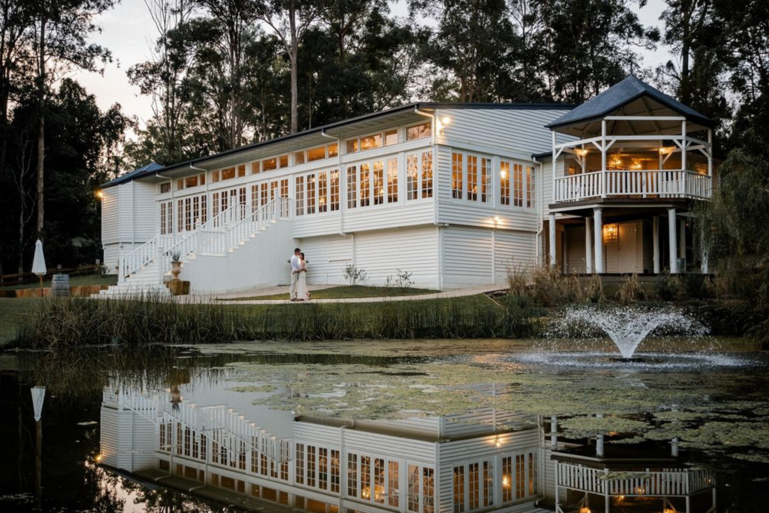 Kwila Lodge beside its lake at dusk, Mudgeeraba
