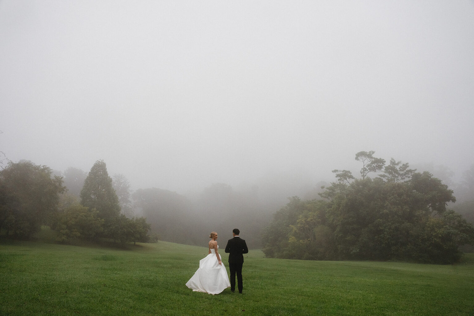 Couple on the lawn in morning mist, Sunshine Coast Hinterland