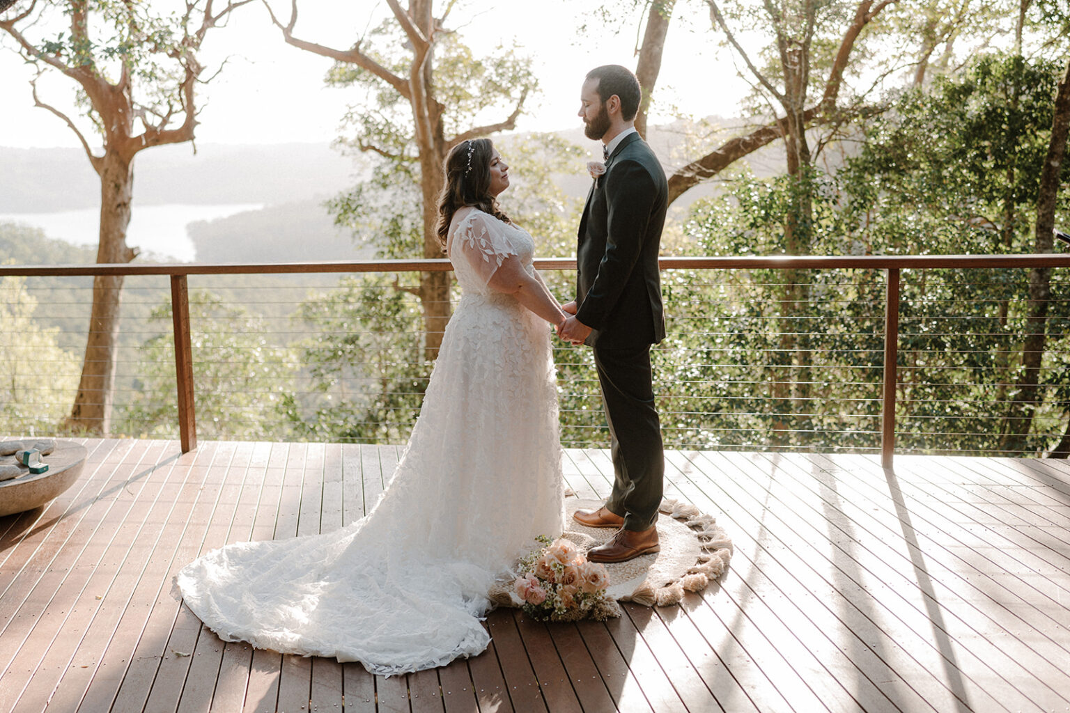 Couple exchanging vows on the deck with valley views