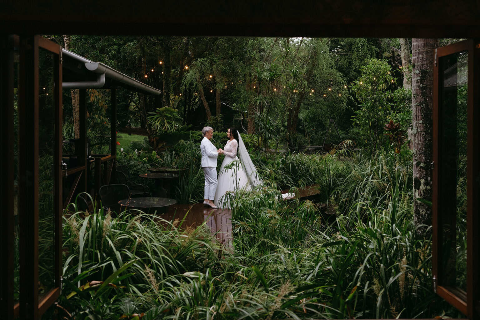Couple among the ferns seen from a villa deck at Spicers Tamarind Retreat