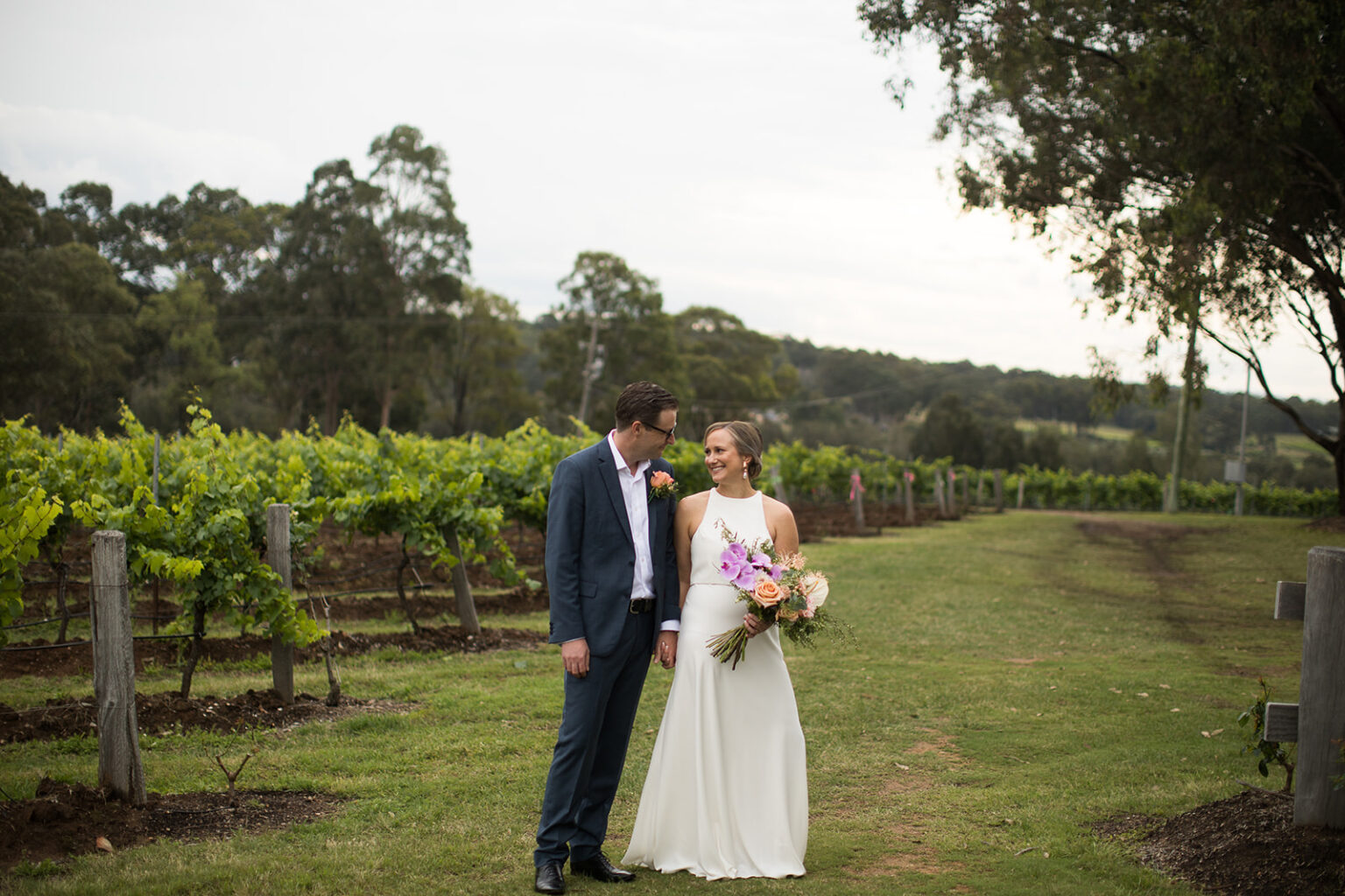 Couple standing among the vines in the Hunter Valley