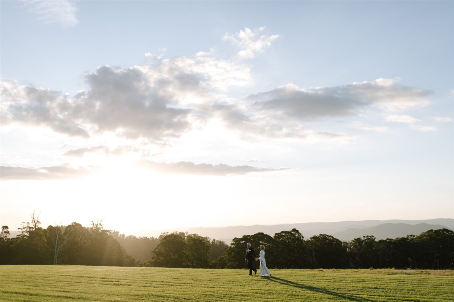 Couple on the open lawn at sunset, Spicers Peak Lodge