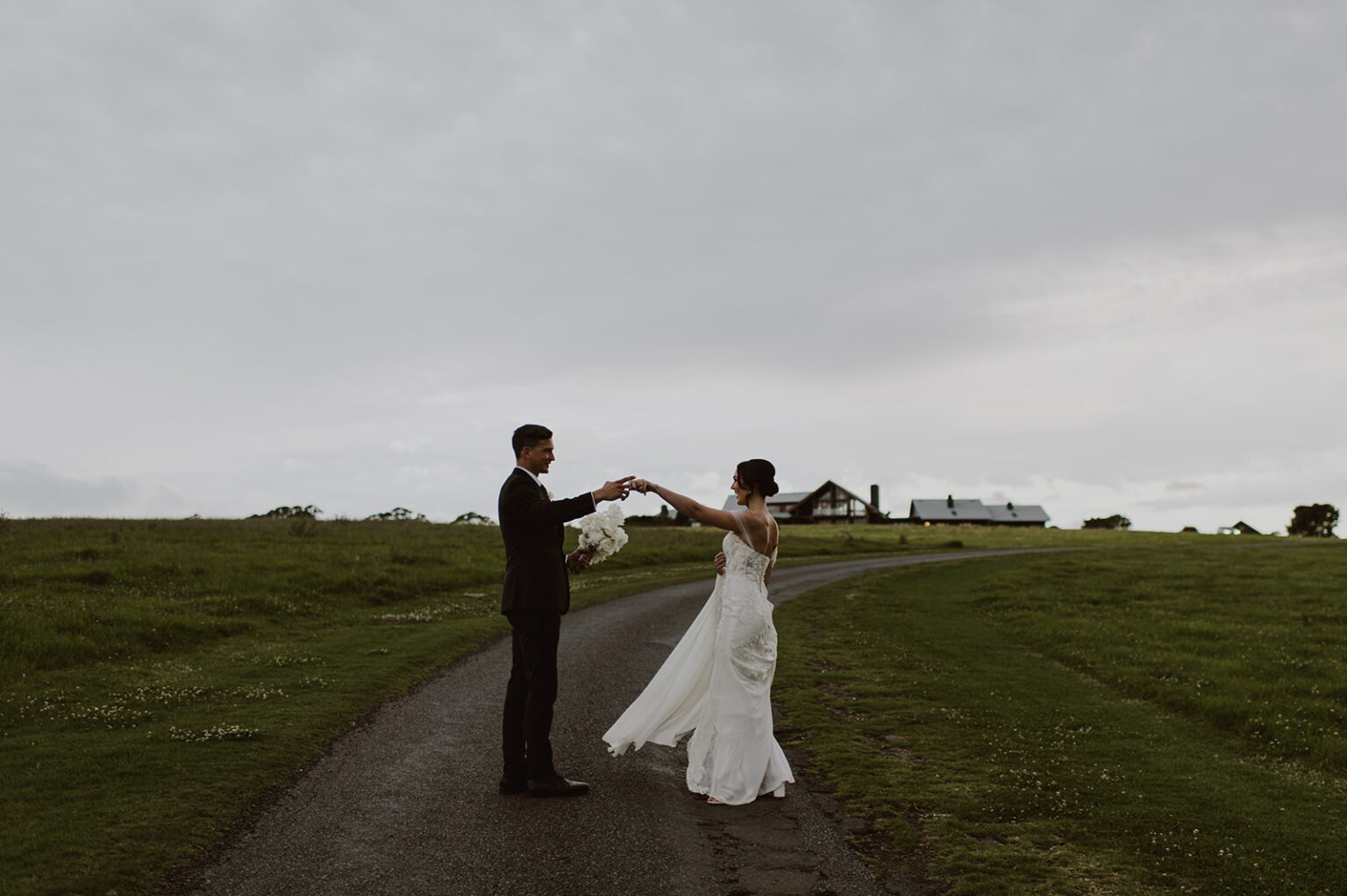 Couple dancing on the driveway at dusk