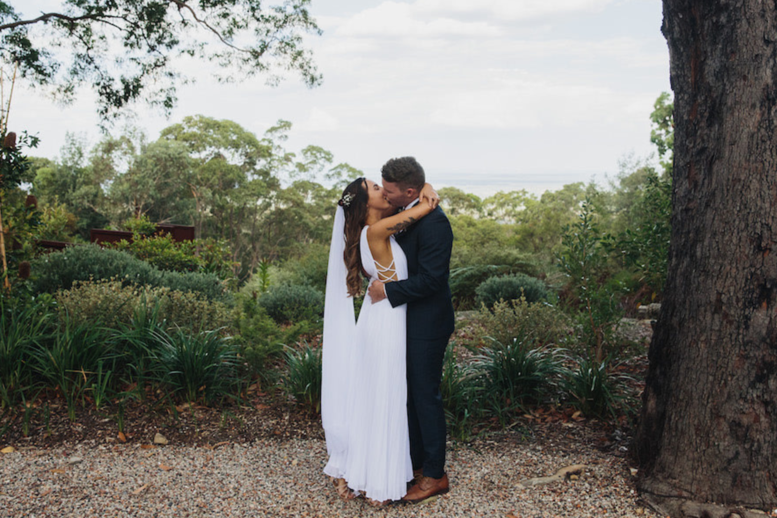 Couple embracing on the garden path at Spicers Sangoma Retreat