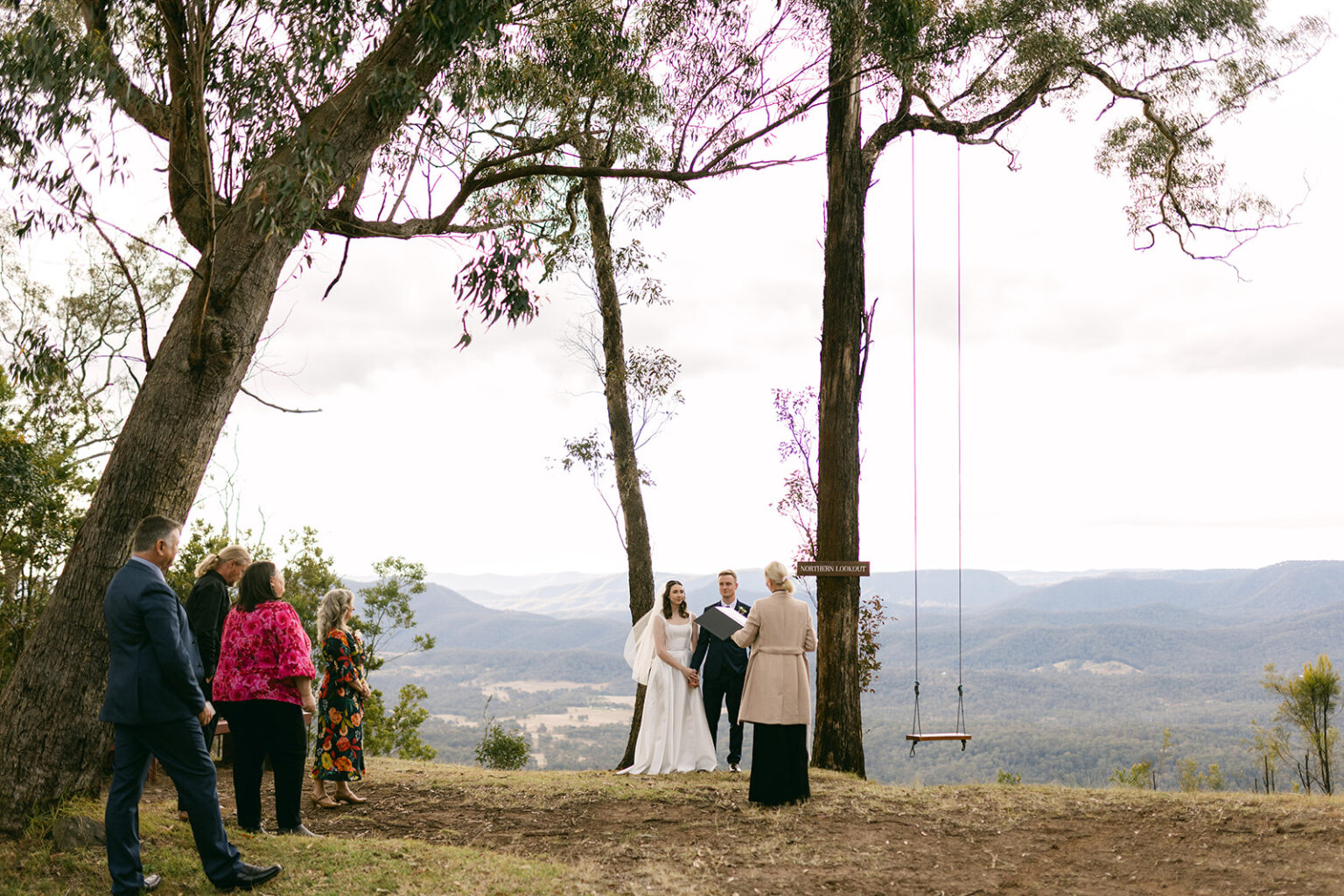 Small ceremony by the tree swing with mountain views