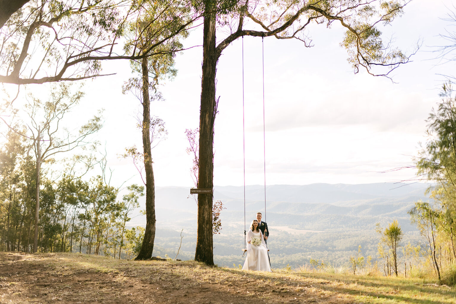Couple beside a tree swing overlooking the Scenic Rim at Spicers Peak Lodge
