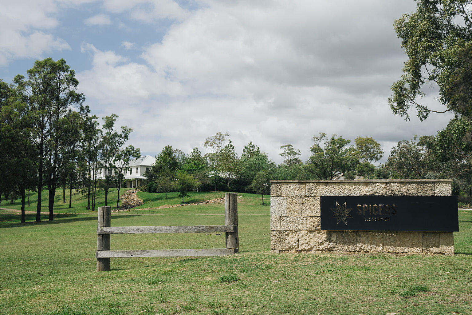 Stone entrance wall and grounds at Spicers Guesthouse