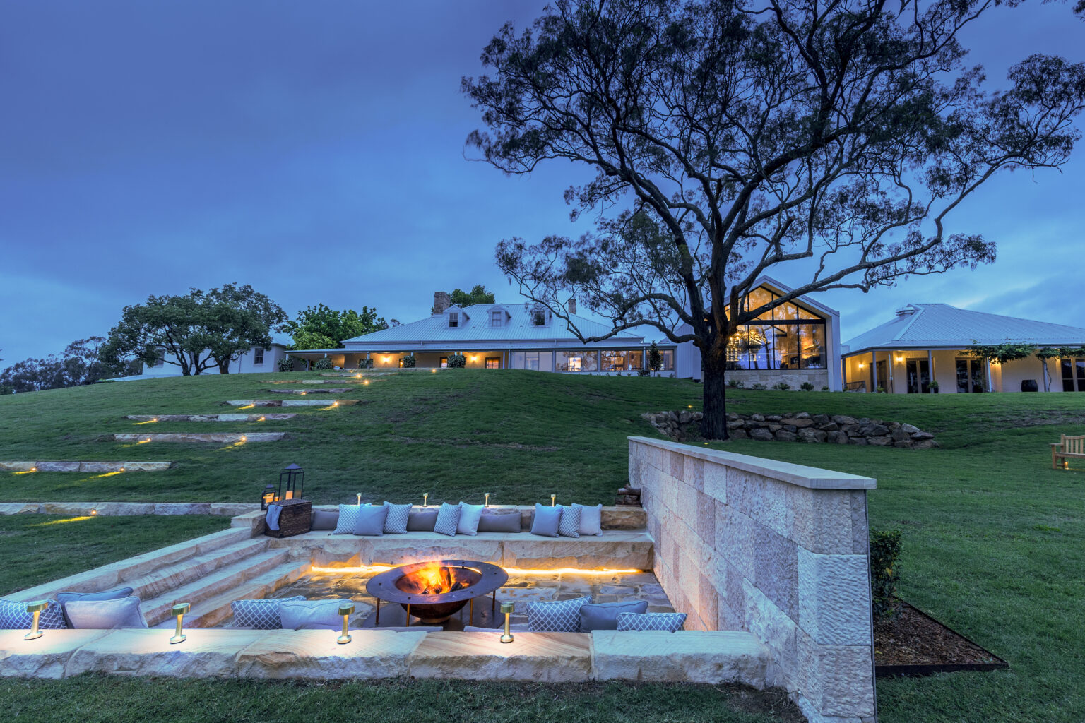 Sunken fire pit lounge at Spicers Guesthouse at dusk