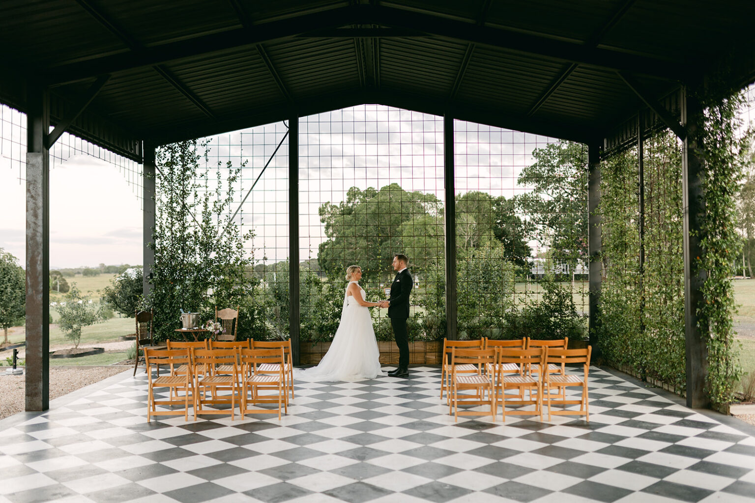 Couple at the altar inside the Conservatory at Twigley Farm