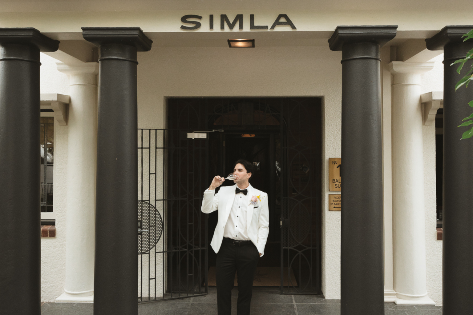 Groom at the Simla entrance of Spicers Balfour Hotel