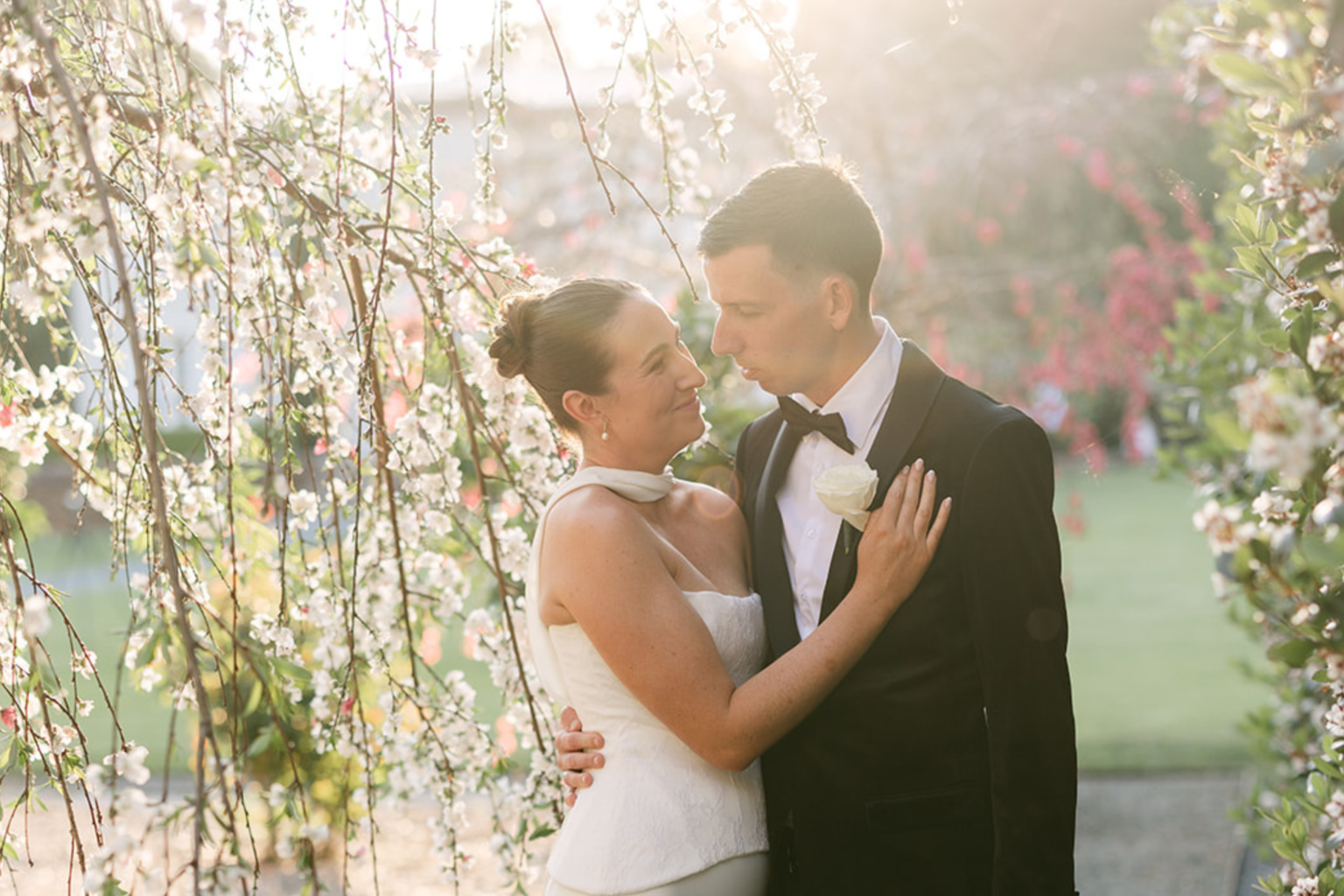 Couple embracing beneath a weeping cherry tree at Wynmère Estate