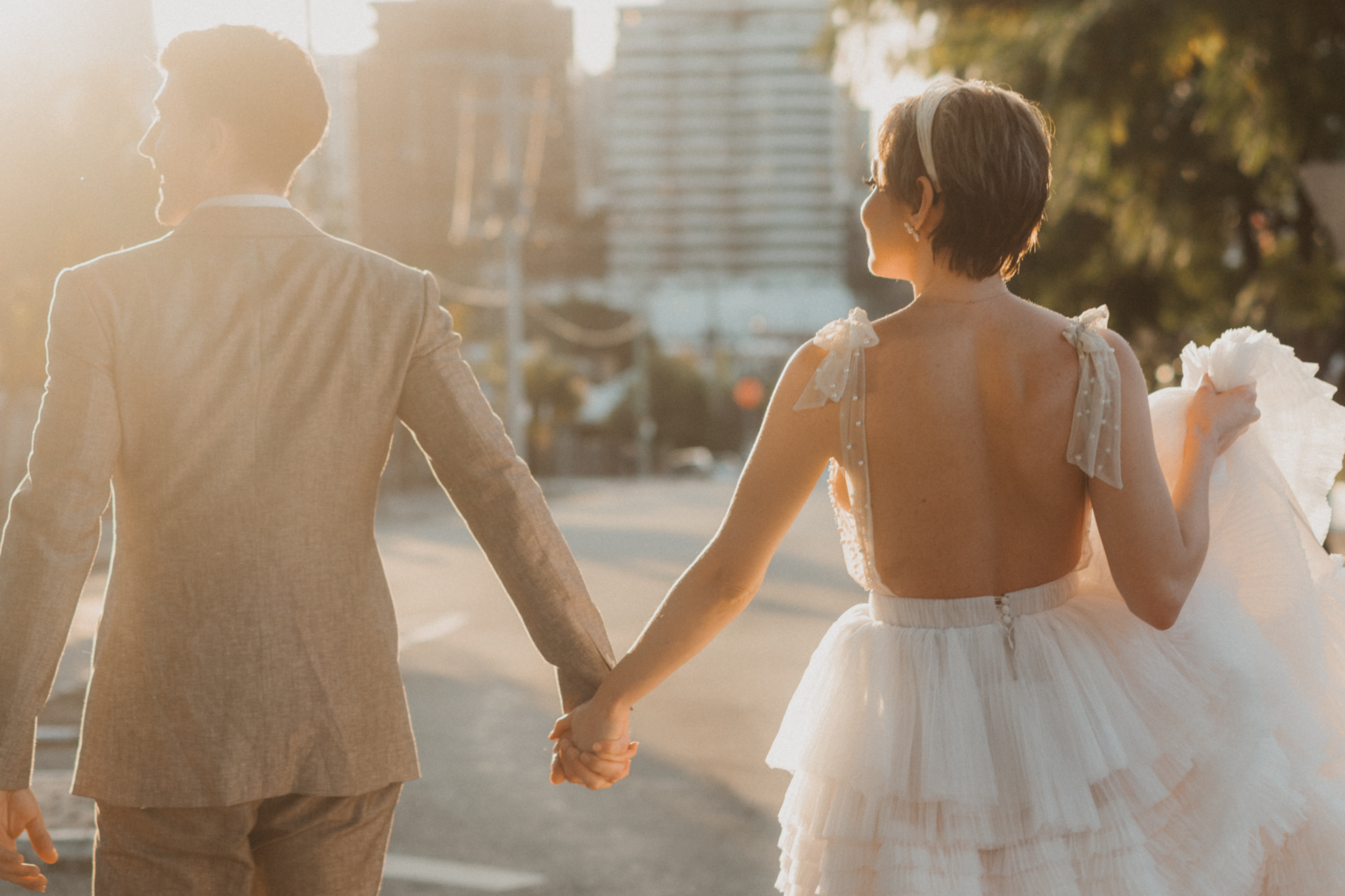 Bride and groom walking hand in hand through Potts Point at sunset