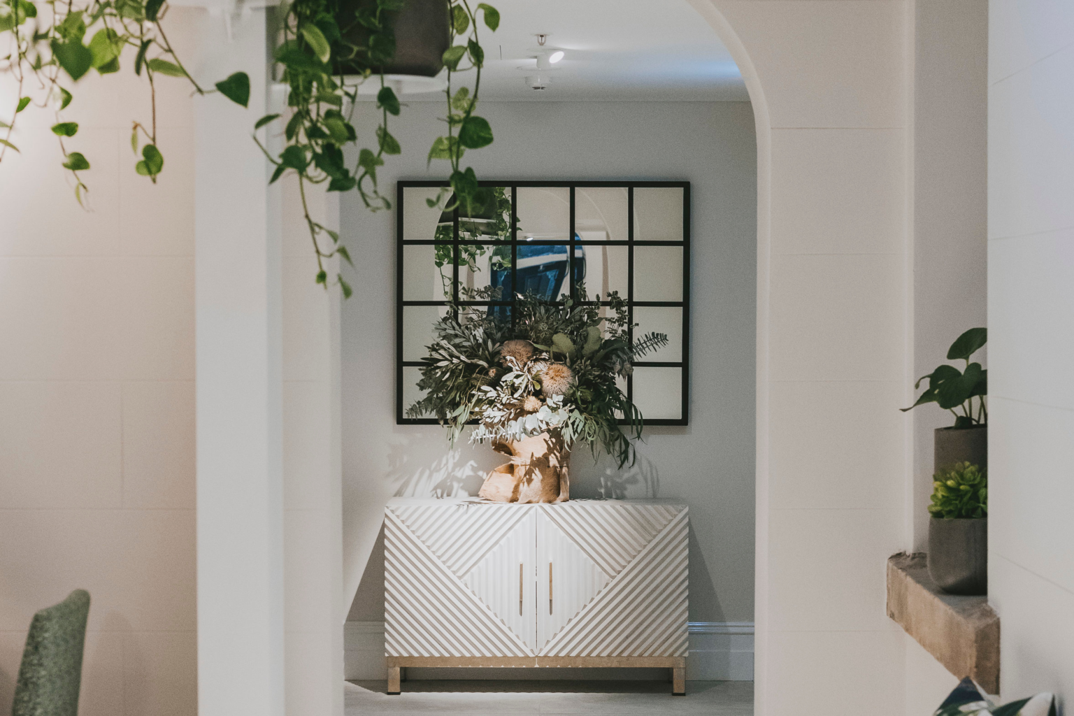 Elegant hallway with plants and a styled sideboard at Spicers Potts Point
