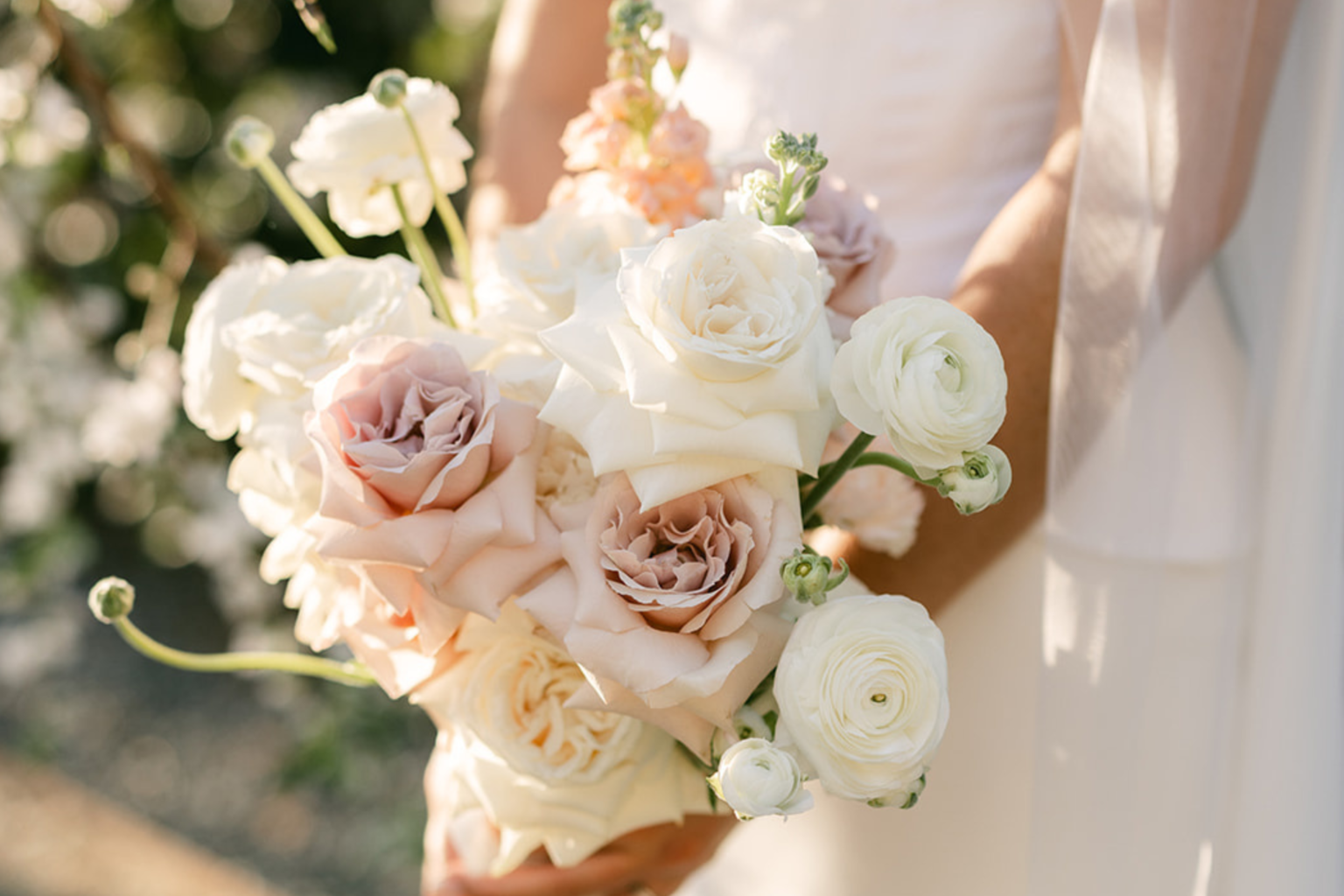 Bride holding a blush and white rose bouquet