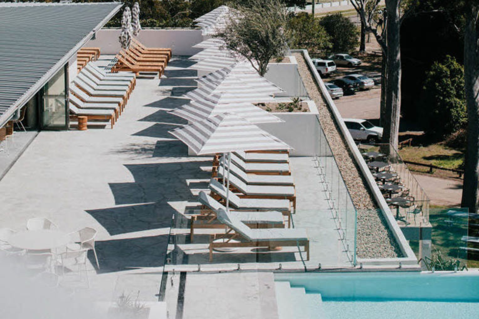 Aerial view of the pool deck with white umbrellas at Bannisters