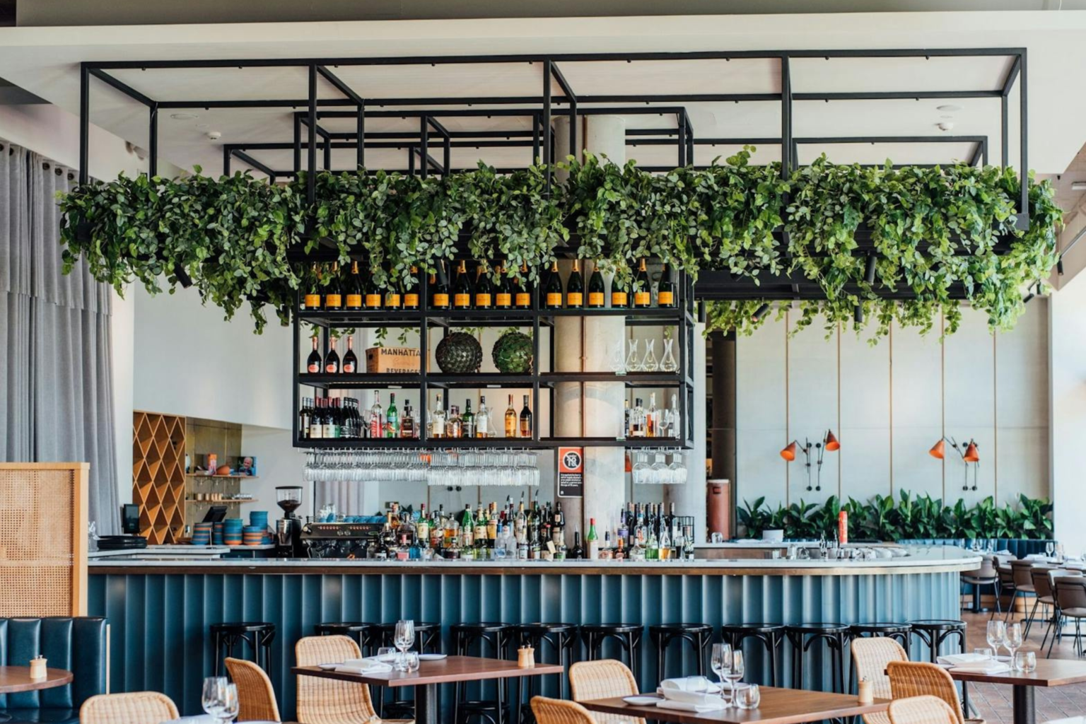 Bar and dining area with hanging greenery at Bannisters