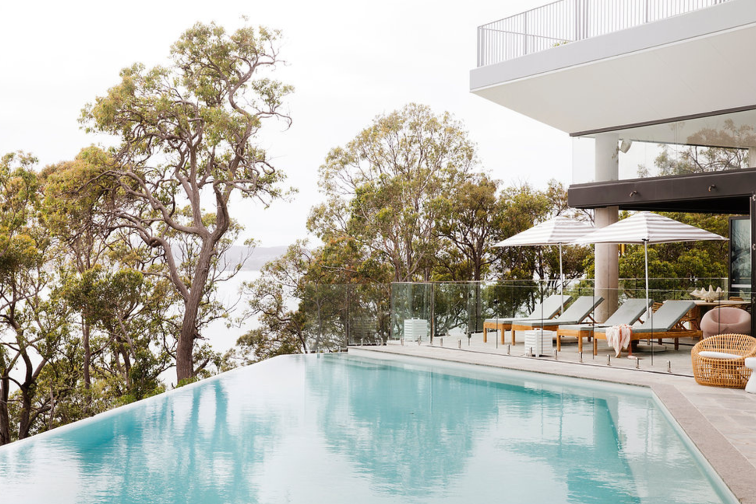 Infinity pool and sun loungers at Bannisters Port Stephens