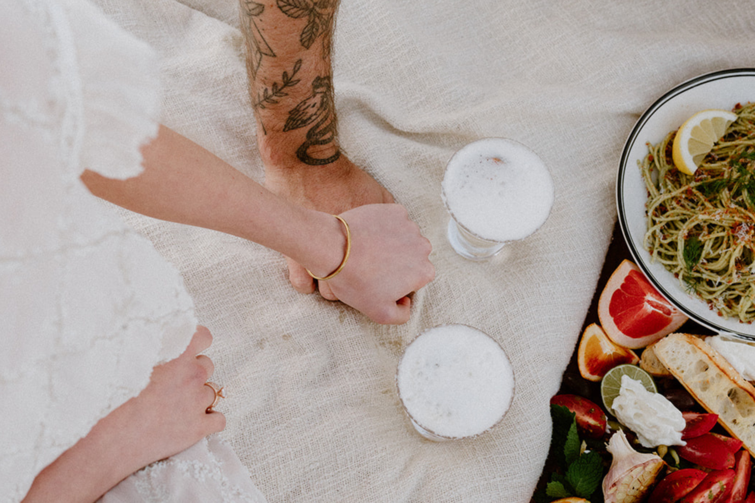 Picnic spread with pasta, fruit and drinks