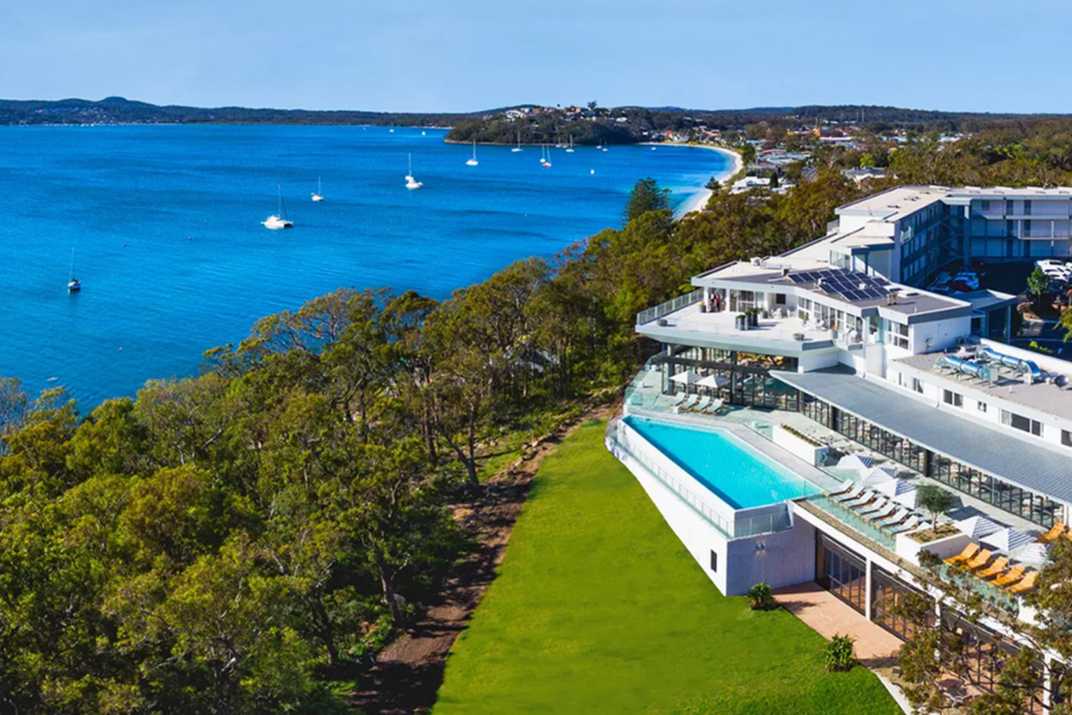 Aerial view of Bannisters Port Stephens above the turquoise bay