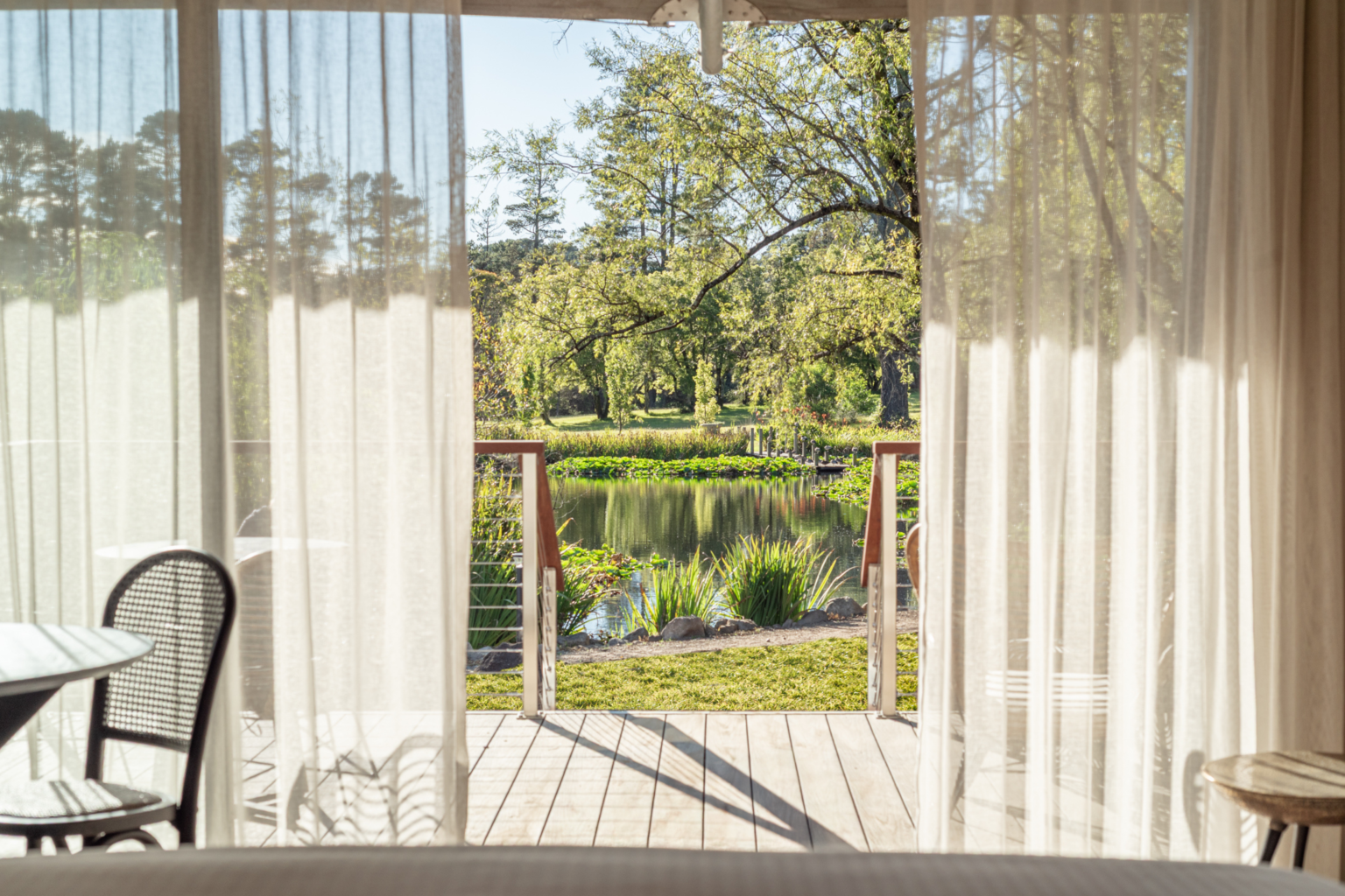 Lakeside Canopy Suite opening onto a deck overlooking the pond