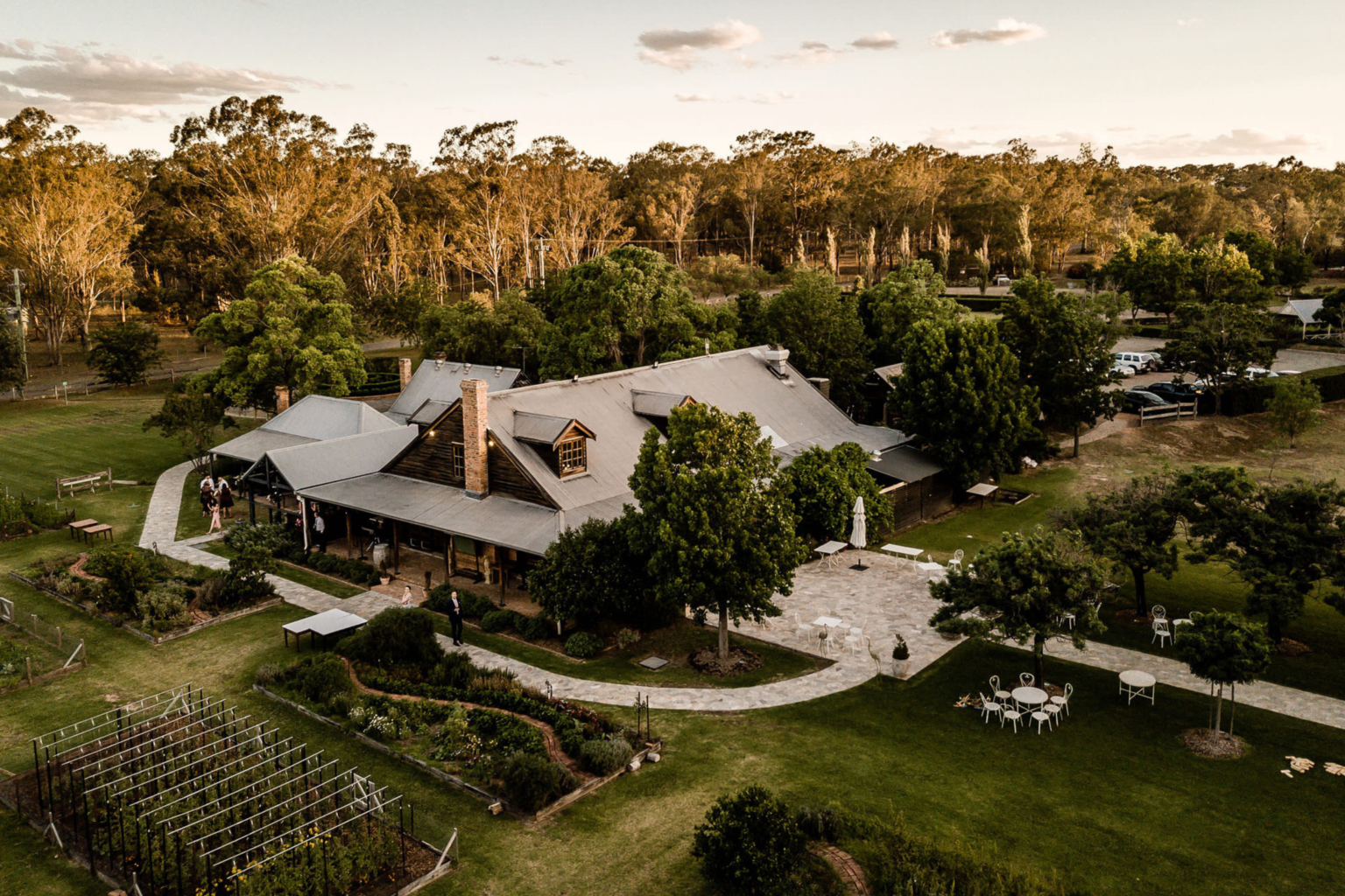 The Convent and its gardens surrounded by bushland at golden hour