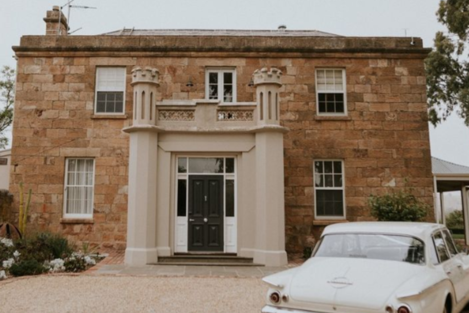Sandstone homestead with a vintage car out front, Kingsford The Barossa