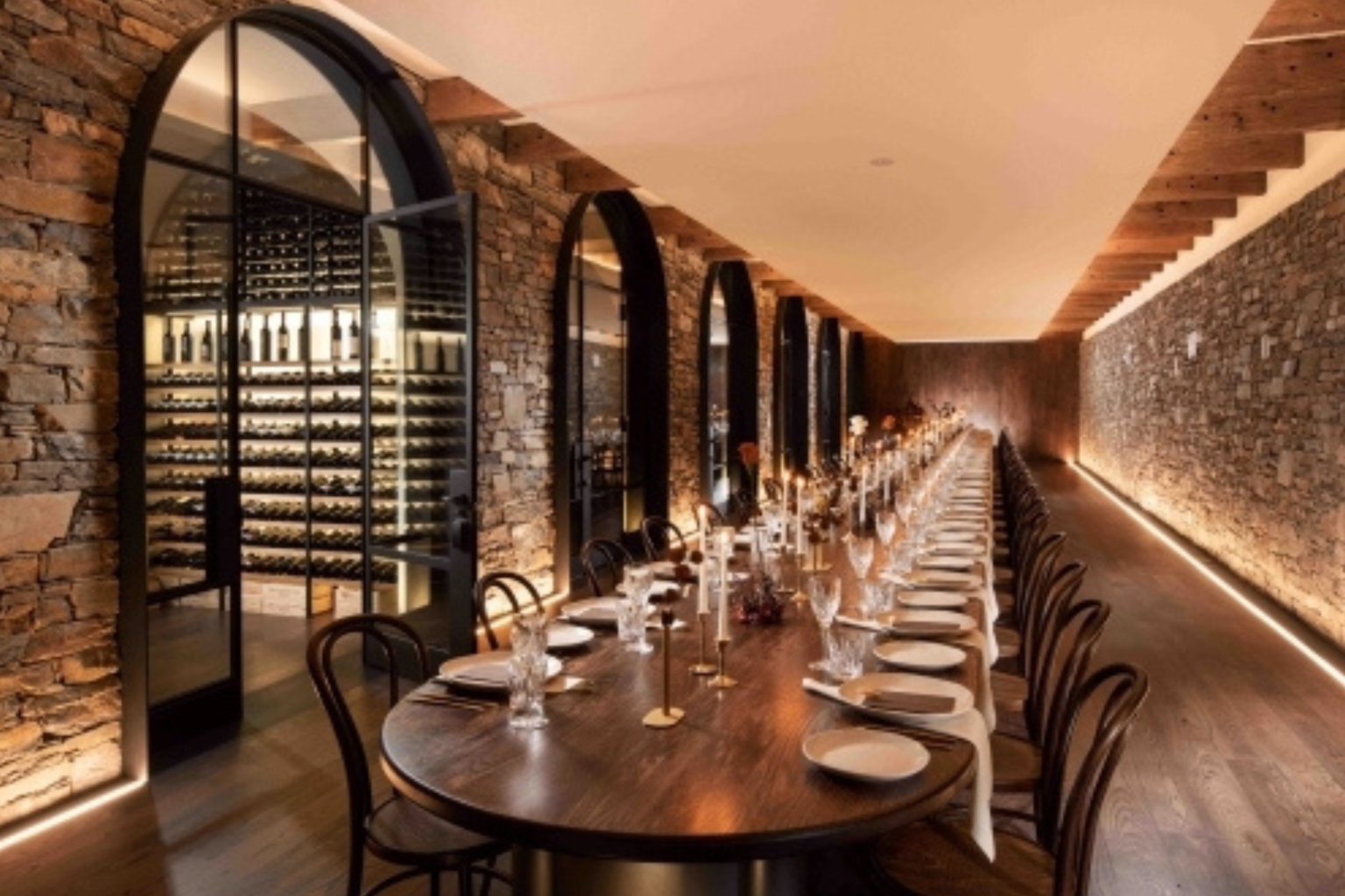 Long dining table set in the wine cellar at Kingsford The Barossa