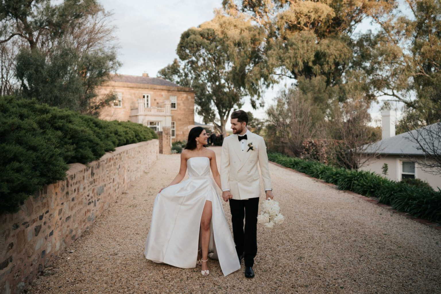 Bride and groom walking down the driveway at Kingsford The Barossa