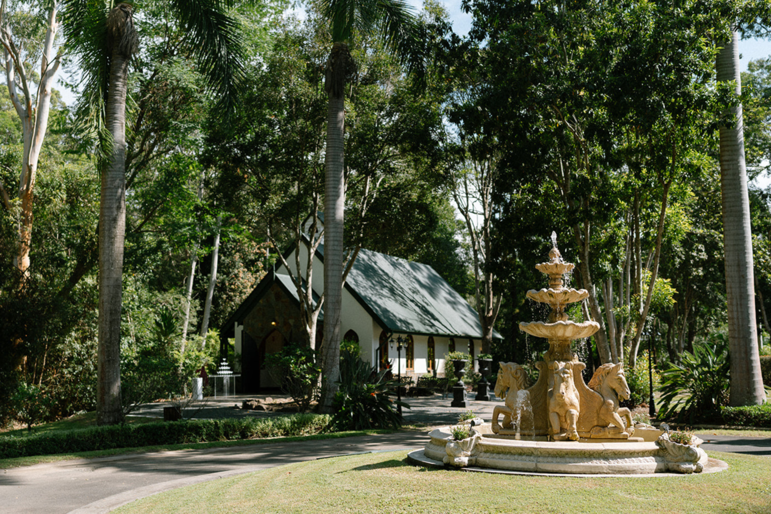Fountain and chapel among the tropical gardens at Coolibah Downs