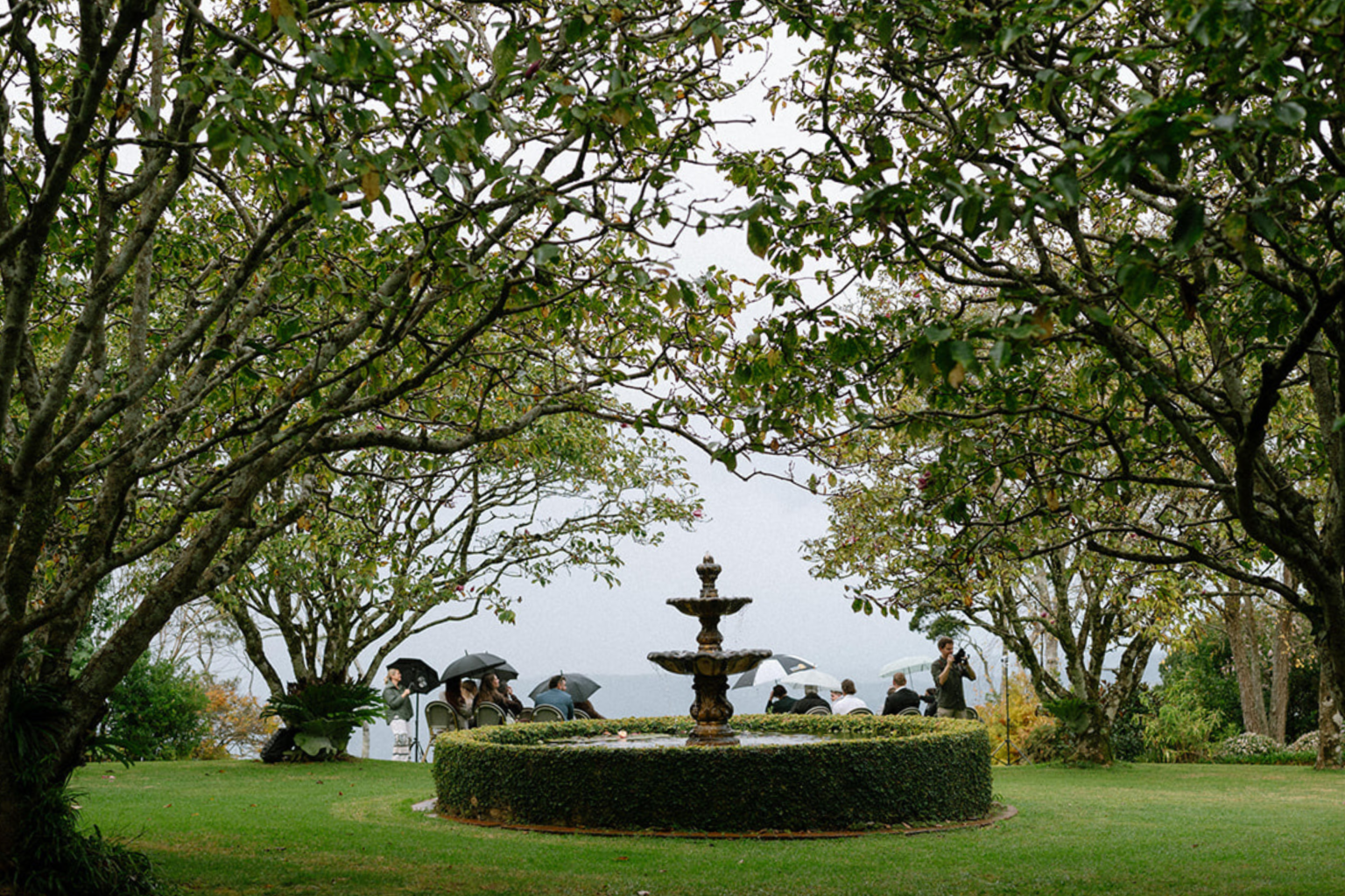 Hedged fountain garden beneath the trees at Highgarden Estate