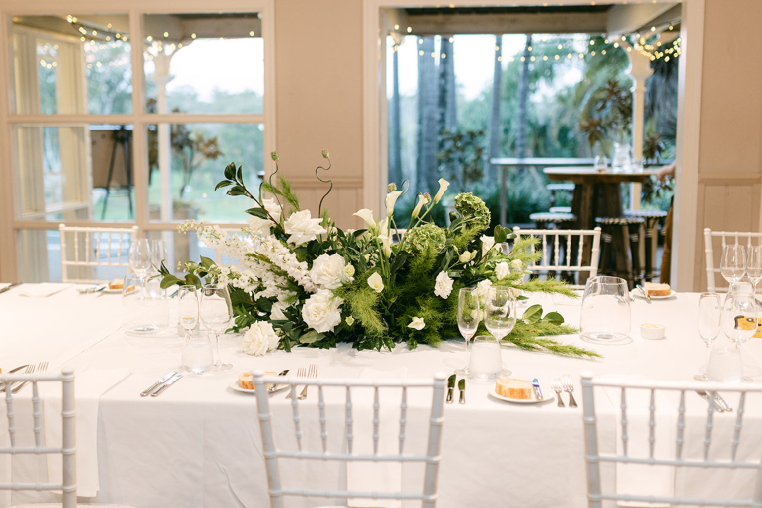Library Bar reception table set with white florals