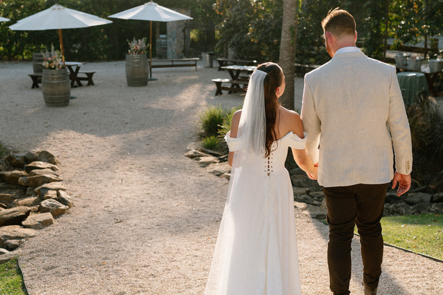 Couple walking hand in hand through the courtyard at Kwila Lodge
