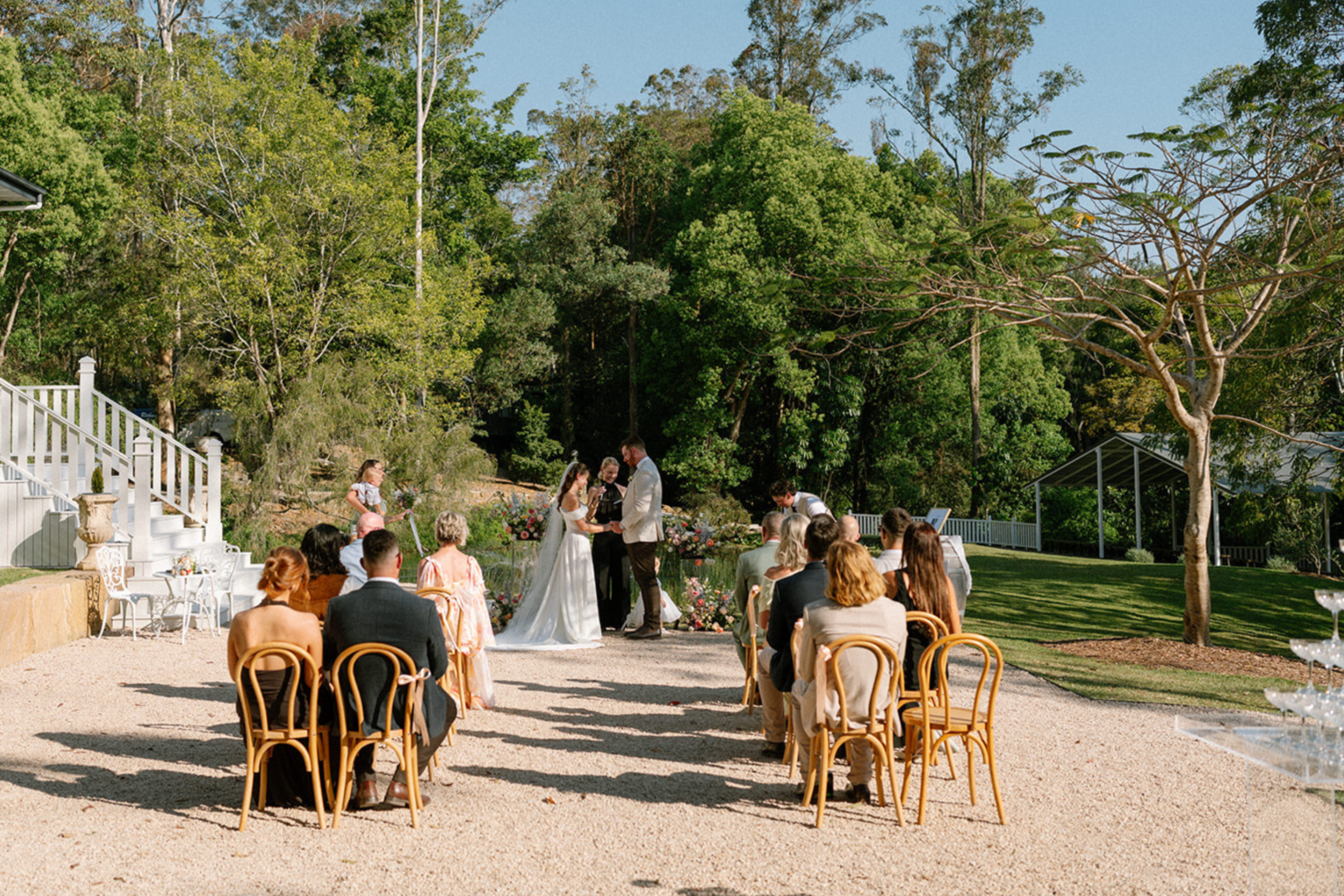 Guests seated for an outdoor ceremony in The Courtyard at Kwila Lodge